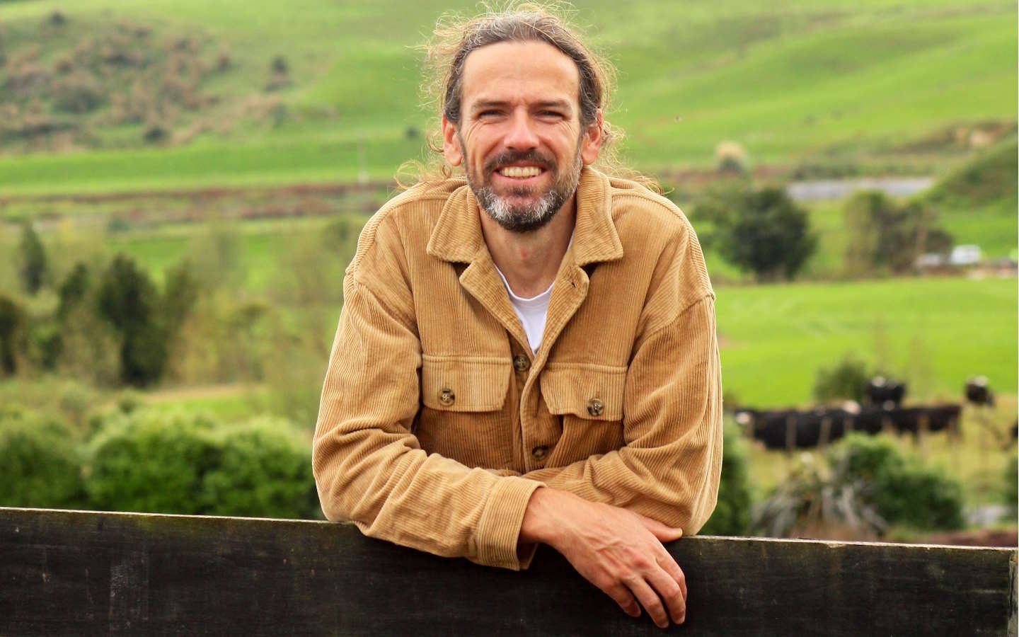 Nigel Pinkerton leaning on a fence in rural Waikato